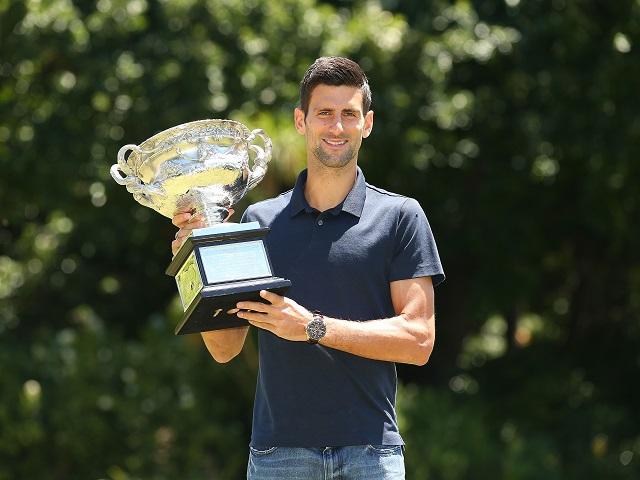 One down, four to go. Novak Djokovic shows off his Australian Open trophy.